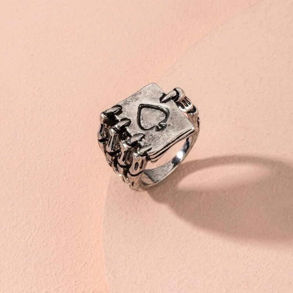 Skeleton hand with playing card ring